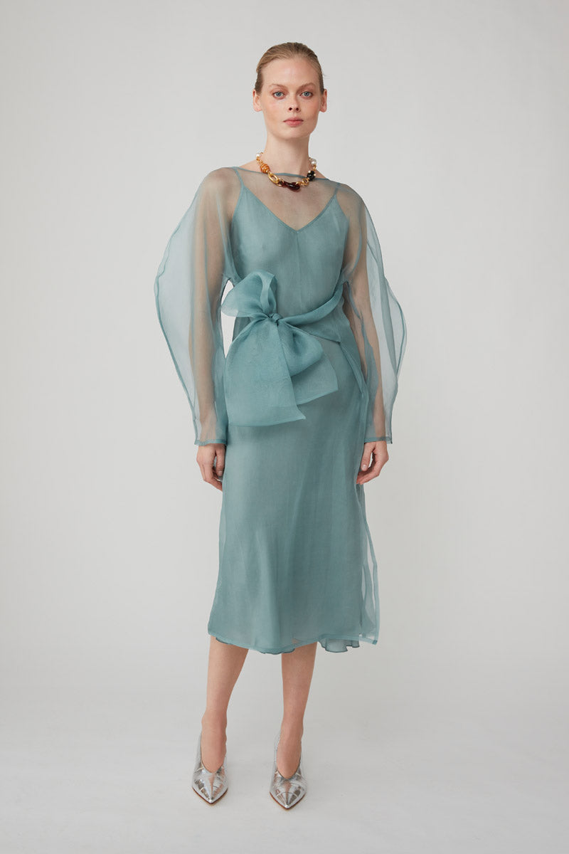 Light blue LIBA organza midi dress by Mastani, featuring elegant fabric and stylish design, perfect for special occasions.