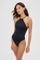 Black Maliluha Matutine one-piece swimsuit shown on a model, featuring a sleek design ideal for beach or poolwear.