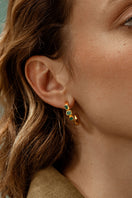 Gold Maya front emerald hoop earrings by Fenomena featuring vibrant emerald stones and sleek gold hoops.