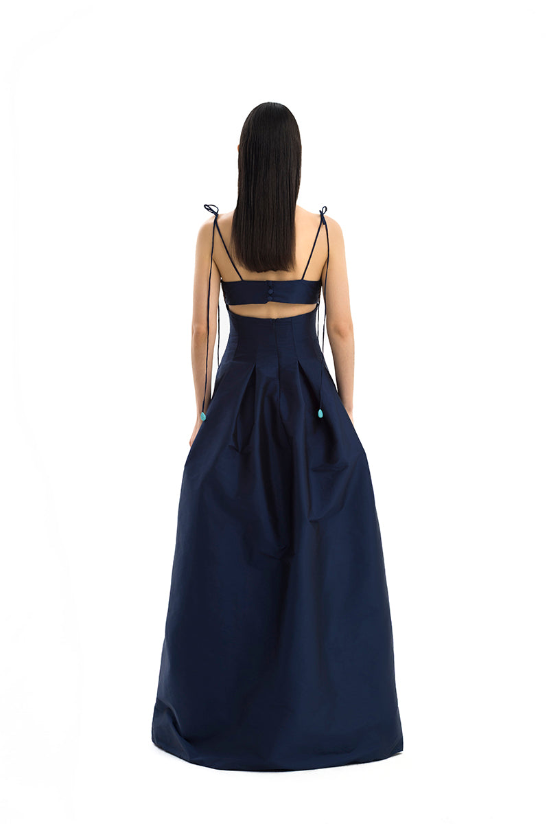 Maylé Vásquez brown and navy gown with elegant design, featuring flowing fabric and intricate details suitable for formal occasions.