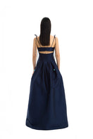 Maylé Vásquez brown and navy gown with elegant design, featuring flowing fabric and intricate details suitable for formal occasions.