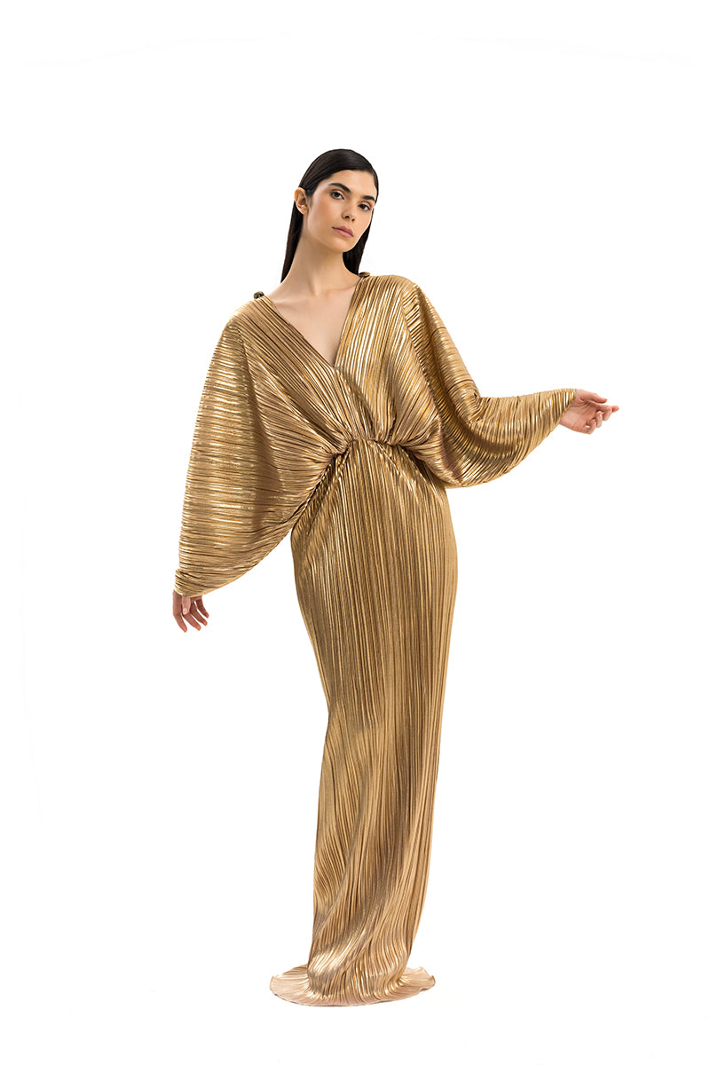 Elegant Candea dress gown by Maylé Vásquez featuring intricate detailing and flowing fabric, perfect for formal occasions.