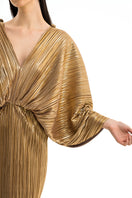 Elegant Maylé Vásquez Cándela gown with intricate embroidery and flowing fabric, perfect for formal events.
