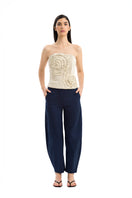 Maylé Vásquez Arena Pants in neutral fabric, featuring a relaxed fit and stylish design, shown in a front view.