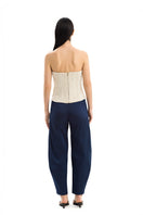 Maylé Vásquez Arena Pants in neutral fabric with a relaxed fit, waistband, and tapered leg design.
