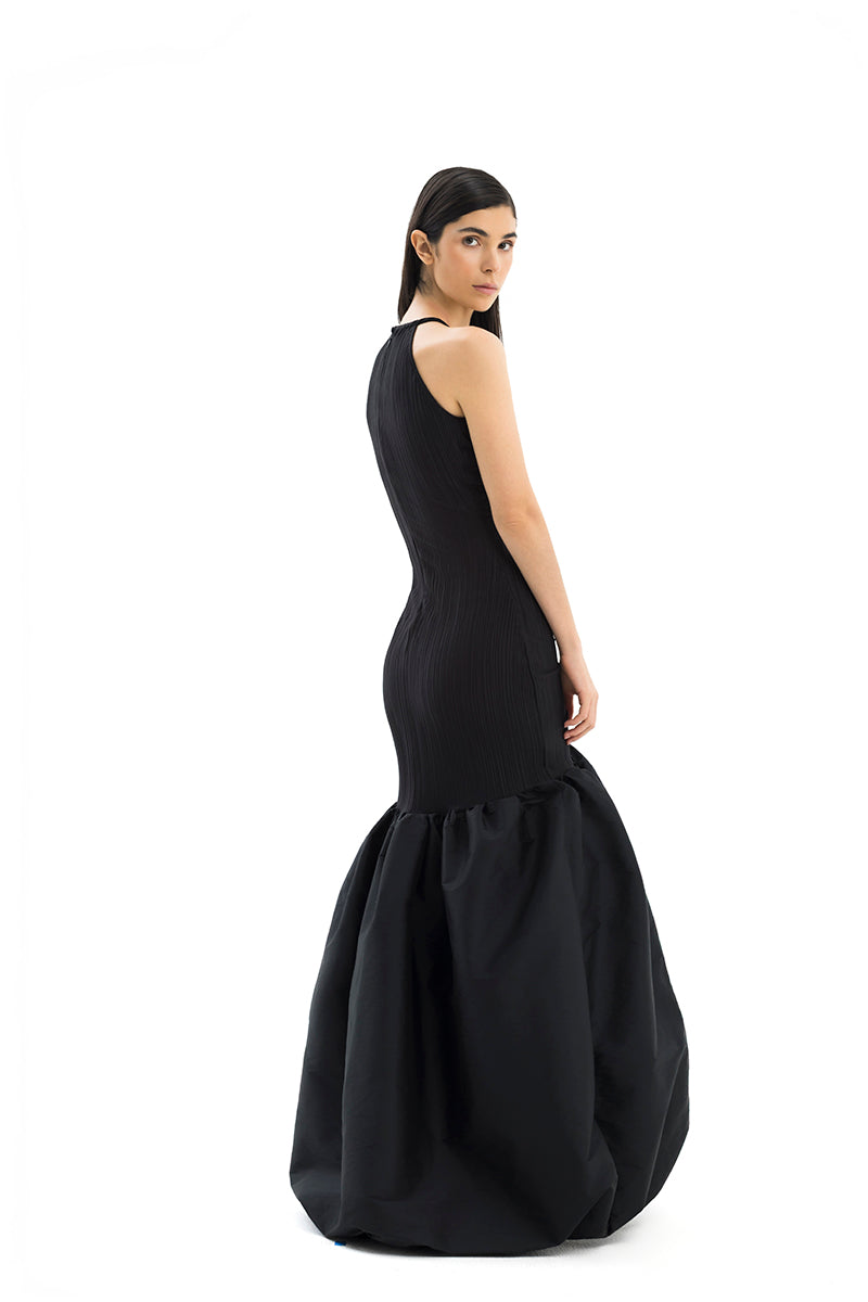 Elegant MENCIA gown by Maylé Vásquez featuring flowing fabric and intricate detailing, perfect for formal occasions.