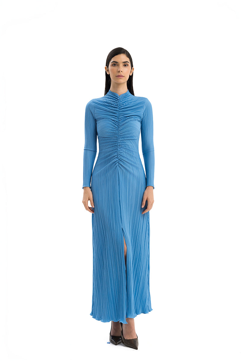 Flowy Maylé Vásquez Aborigen maxi dress with vibrant patterns, long sleeves, and a relaxed fit, perfect for casual or elegant occasions.
