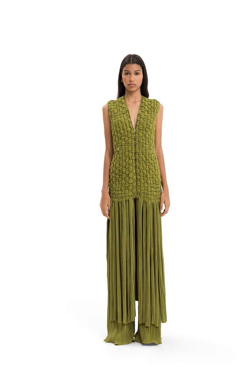 Maylé Vásquez Palma vest, stylish sleeveless top with a textured fabric, worn over a shirt for a casual, layered look.