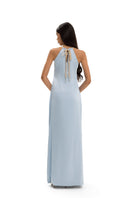 Maylé Vásquez Solara halterneck maxi dress in flowing fabric, featuring a stylish halter neckline and elegant design.