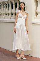 Nana Jacqueline Meadow Dress in champagne, open-back maxi dress with flowing fabric, perfect for elegant summer occasions.