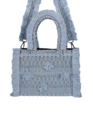Medium Bani Poka Balay top handle bag with sleek design and sturdy handles, shown in a stylish, neutral-toned fabric.