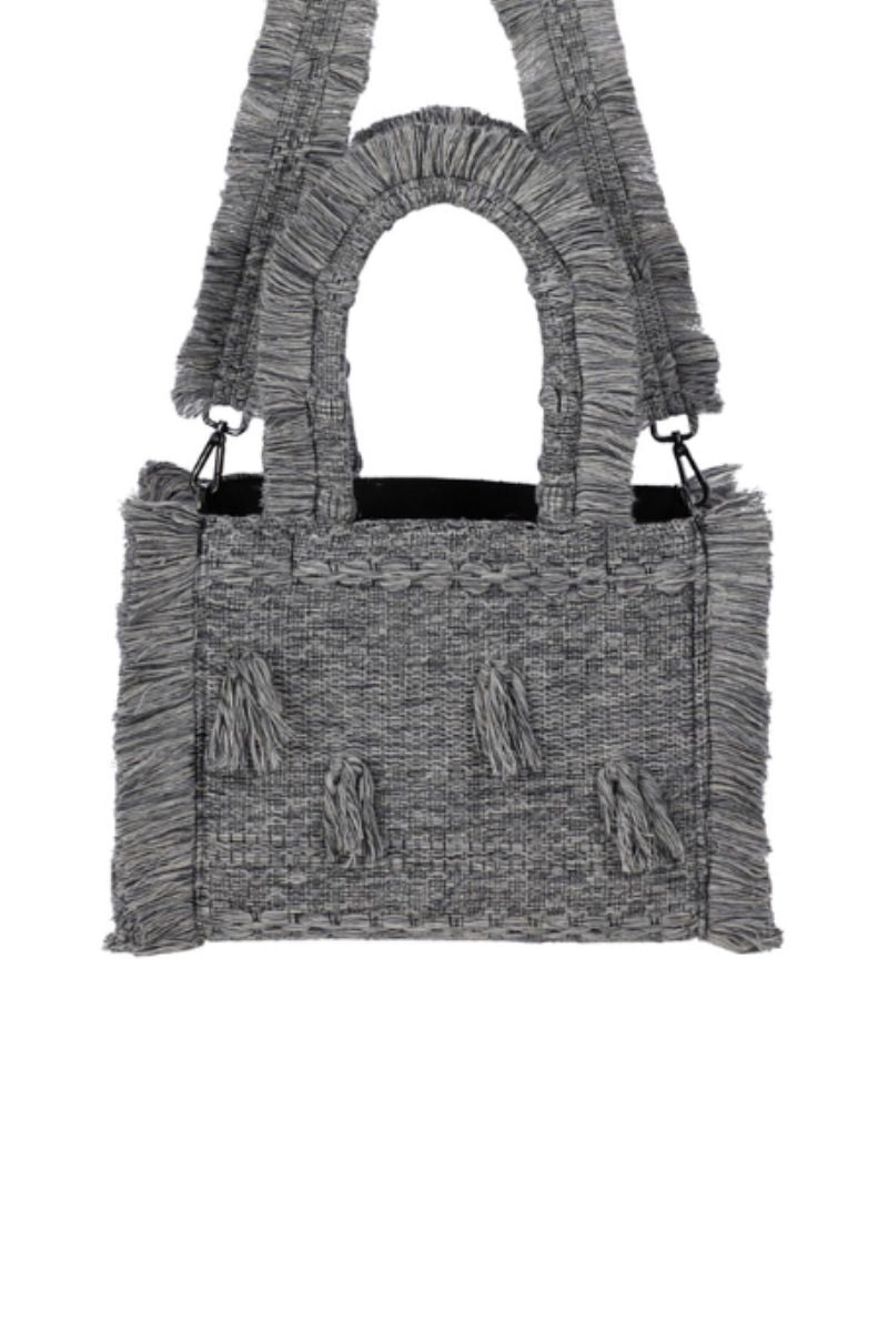 Medium Bani Poka Gardo top handle bag with sleek design and structured shape, showcased in a stylish photoshoot.