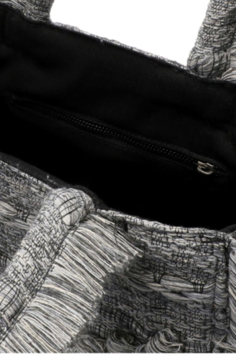 Medium Bani Poka Gardo top handle bag with structured design and short handles, showcasing its elegant and versatile style.