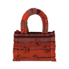 Medium Bani Poka organza top handle bag featuring a structured design and elegant fabric with a short handle.