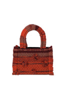 Medium Bani Poka organza top handle bag featuring a structured design and elegant fabric with a short handle.