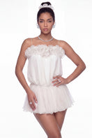 White Melody mini dress by Nana Jacqueline, shown on a model with flowing fabric and stylish design, perfect for casual or dressy occasions.