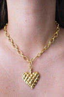 Gold melted heart necklace by Oz Objects featuring a unique, sculpted heart pendant on a delicate chain.