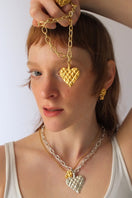 Gold melted heart necklace from Oz Objects, stylish jewelry piece featuring a unique melted heart pendant.
