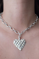 Silver melted heart necklace by Oz Objects, featuring a unique, abstract heart pendant on a delicate chain.