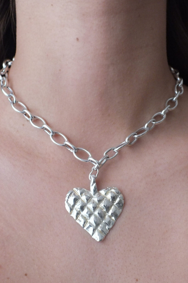 Silver melted heart necklace by Oz Objects, featuring a unique, abstract heart pendant on a delicate chain.