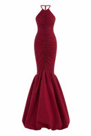 Red Mencia gown by Maylé Vásquez from the CULT MIA X MALYÉ VÁSQUEZ collection, shown on a model with flowing fabric.