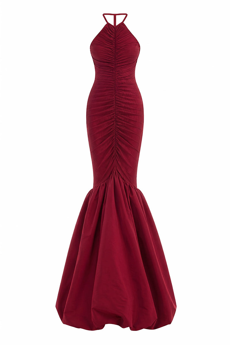 Red Mencia gown by Maylé Vásquez from the CULT MIA X MALYÉ VÁSQUEZ collection, shown on a model with flowing fabric.