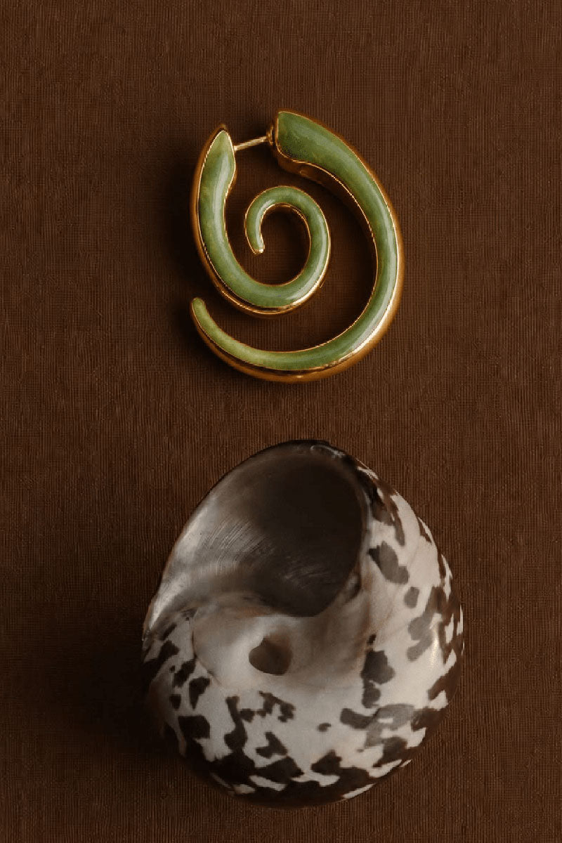 Sara & Flora spiral cat hoop earrings with sleek, curved design on a neutral background.