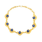 Blue meteorite pendant necklace by Jude Benhalim featuring a gold chain, showcasing a striking celestial-inspired design.