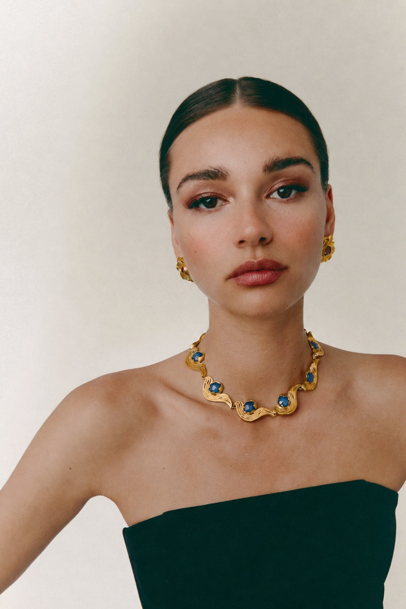 Blue meteorite necklace by Jude Benhalim featuring a striking gold chain and a unique meteorite pendant.