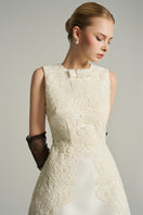 Ivory sleeveless knee-length midi dress by I.H.F Studio with lace fabric and a crystal-embellished bow detail.