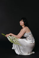 Ivory silk bridal nightgown by NK IMODE, featuring elegant long design with delicate lace details and flowing fabric.