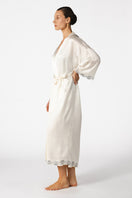 Ivory silk bridal robe by NK IMODE, featuring long, flowing design with delicate lace and satin accents, perfect for wedding preparation.