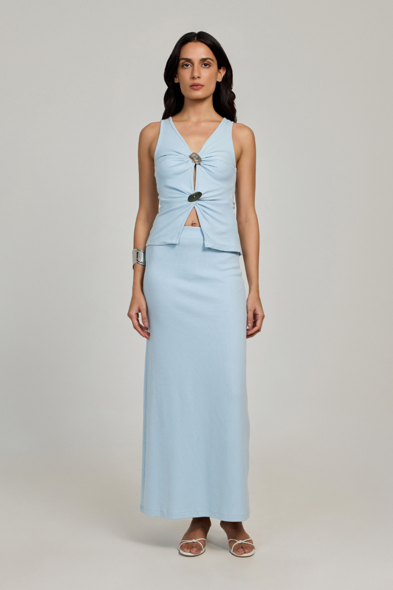 Baby blue Minato maxi skirt by Summer Away with flowing fabric and a high waist, shown on a hanger.