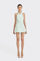 Light blue CULT MIA X STOLEN STORES bow mini dress displayed on a hanger, showcasing its stylish design and fabric details.