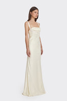 Light yellow maxi dress with bow detail from Stolen Stores, featuring a flowing silhouette and stylish design.