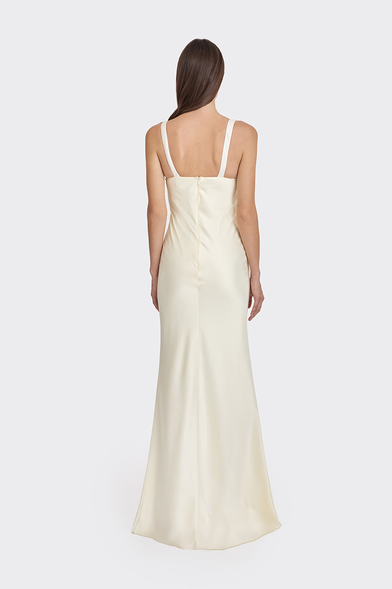 Light yellow Stolen Stores mini bow maxi dress displayed on a hanger, showcasing its flowing fabric and elegant design.