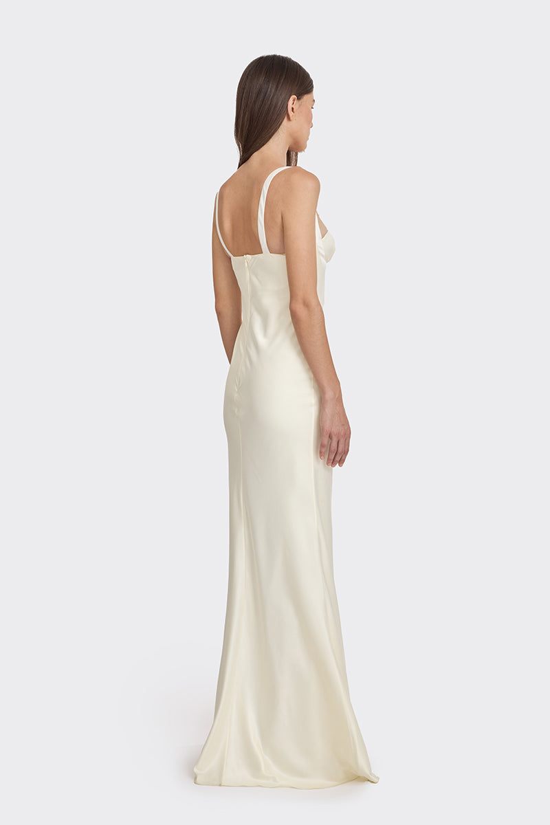 Light yellow maxi dress by Stolen Stores featuring a mini bow design, shown on a model with flowing fabric and elegant style.