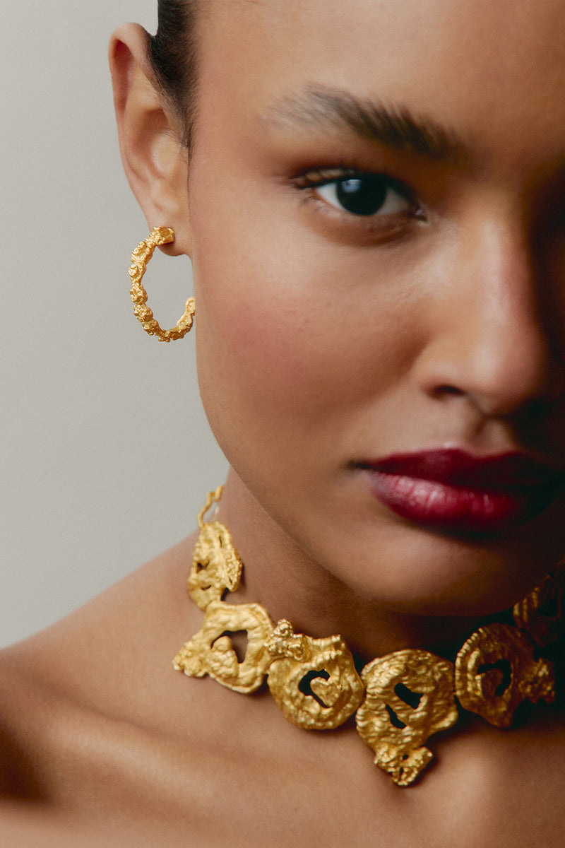 Gold mini pebble earrings by Jude Benhalim featuring small, smooth pebble-shaped design in a minimalist style.