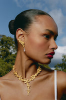 Mini gold riverstone earrings by Jude Benhalim featuring small, elegant gold earrings with smooth riverstone accents.