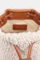 Saonara mini bucket top handle bag in cozy off-white fabric with a rounded shape and top handle design.