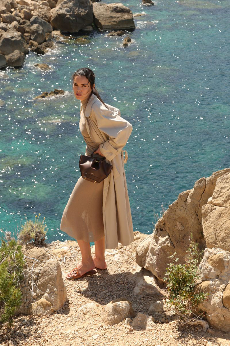 Mini Capazo bag in rich chocolate leather featuring a top handle, from Saonara, showcasing its compact and stylish design.
