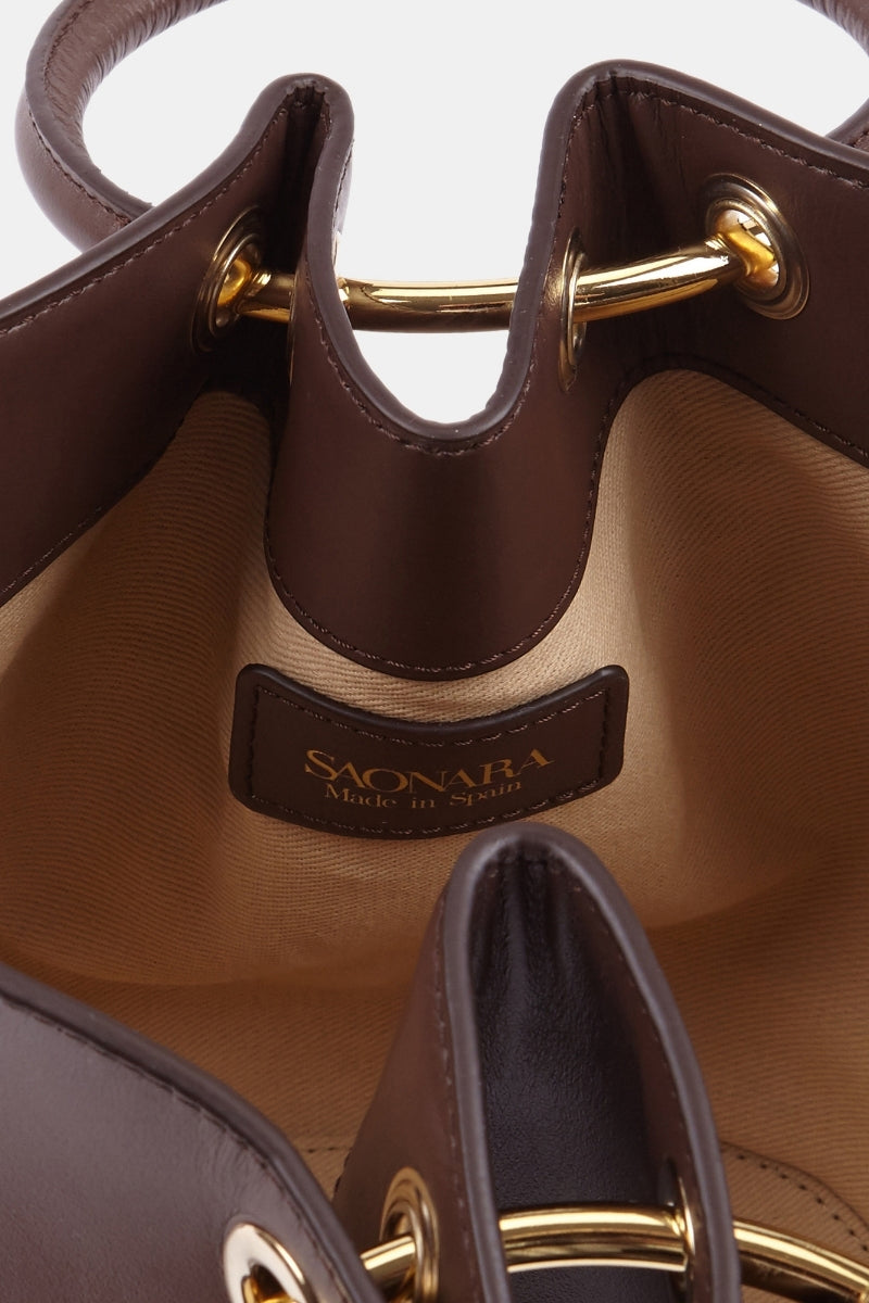 Mini Capazo bag in rich chocolate leather with top handle, stylish and compact from Saonara's collection.