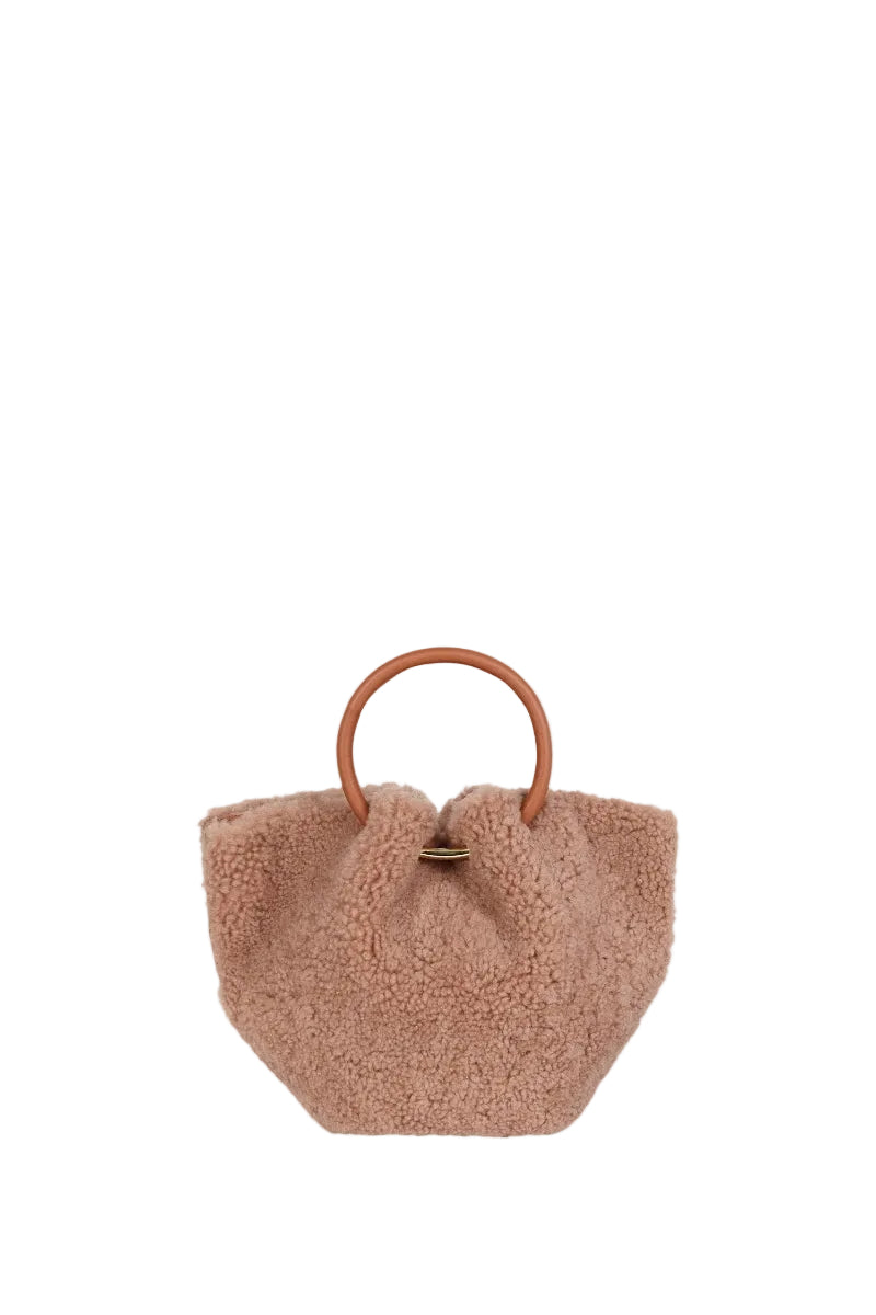 Saonara mini capazo top handle bag in warm caramel color, showing its cozy woven texture and compact design.