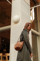 Saonara mini capazo top handle bag in caramel cozy leather, showing its compact, stylish design with sturdy handles.