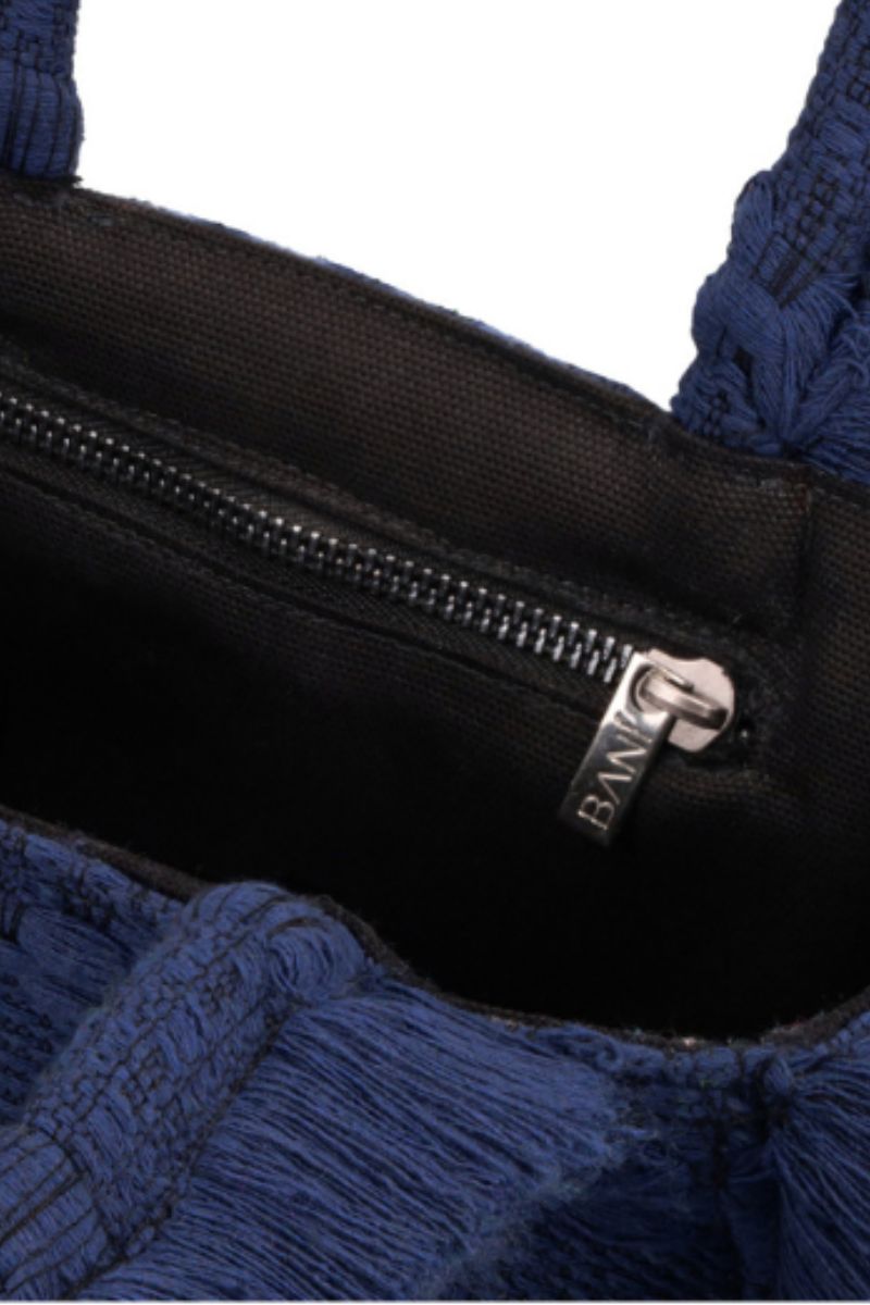 Navy blue mini Poka top handle bag by Bani with a structured design and short top handle, perfect for stylish everyday use.