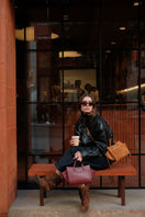 Saonara mini shopping shoulder bag in berry leather with a compact design and sleek strap, perfect for everyday use.