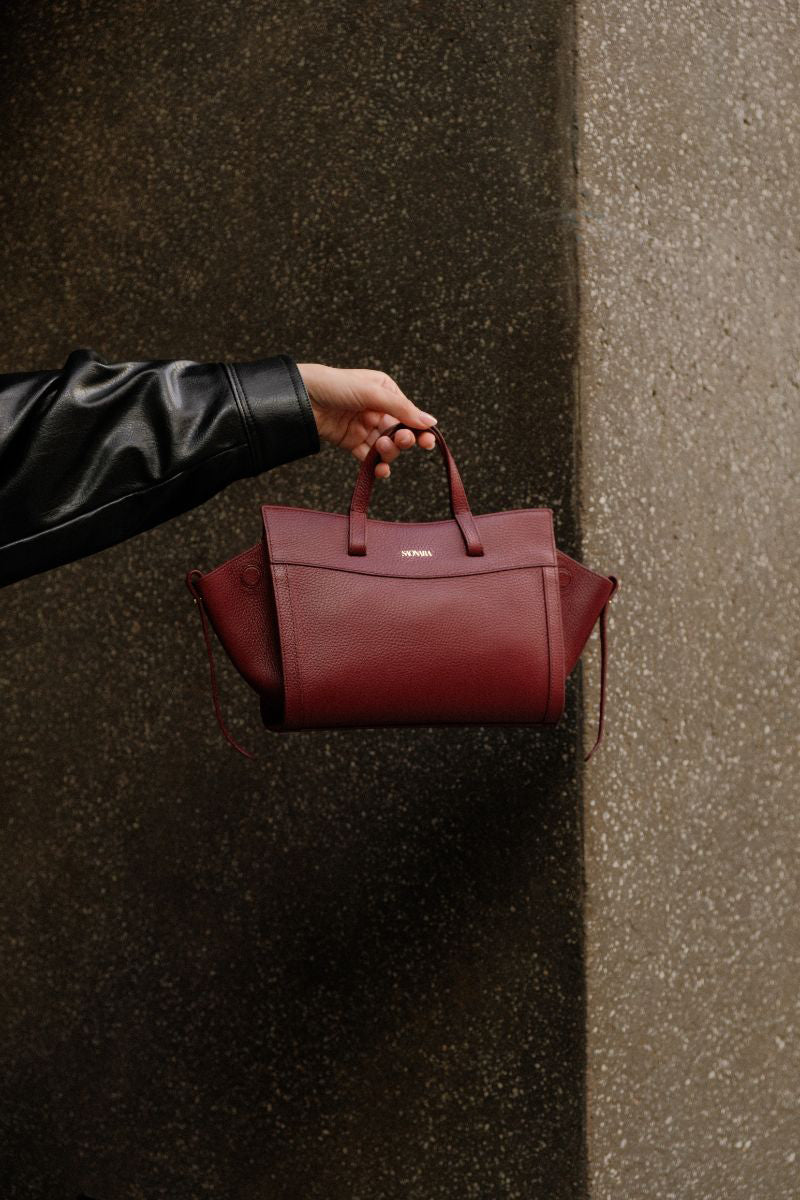 Saonara mini shopping shoulder bag in berry leather with top handle and adjustable strap, stylish and compact for everyday use.