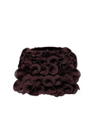 Brown Stolen Stores spiral mini skirt displayed on a model, showcasing its fitted design and stylish spiral pattern.