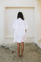 White MINITA blouse by ANA + MARIA in a loose, stylish tops design, shown on a neutral background.
