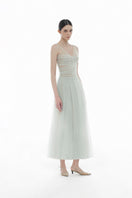 Mint V-neck draped midi dress by Montsand, featuring flowing fabric and elegant design, shown on a model.